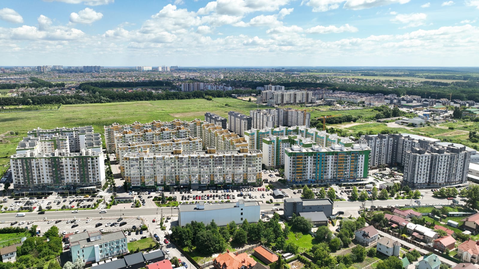 Evromisto by SAVO in the Kyiv region seen from the air: the whole district of finished blocks with open fields around it and the town on the horizon