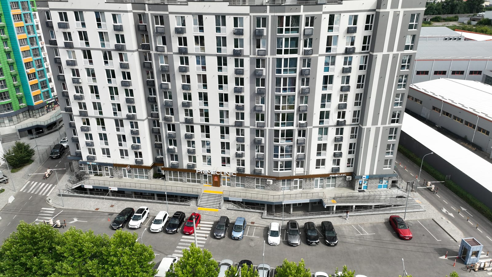 The Prime Clinic dental practice on the ground floor of a residential block in Evromisto by SAVO, with its own entrance, ramp and parking